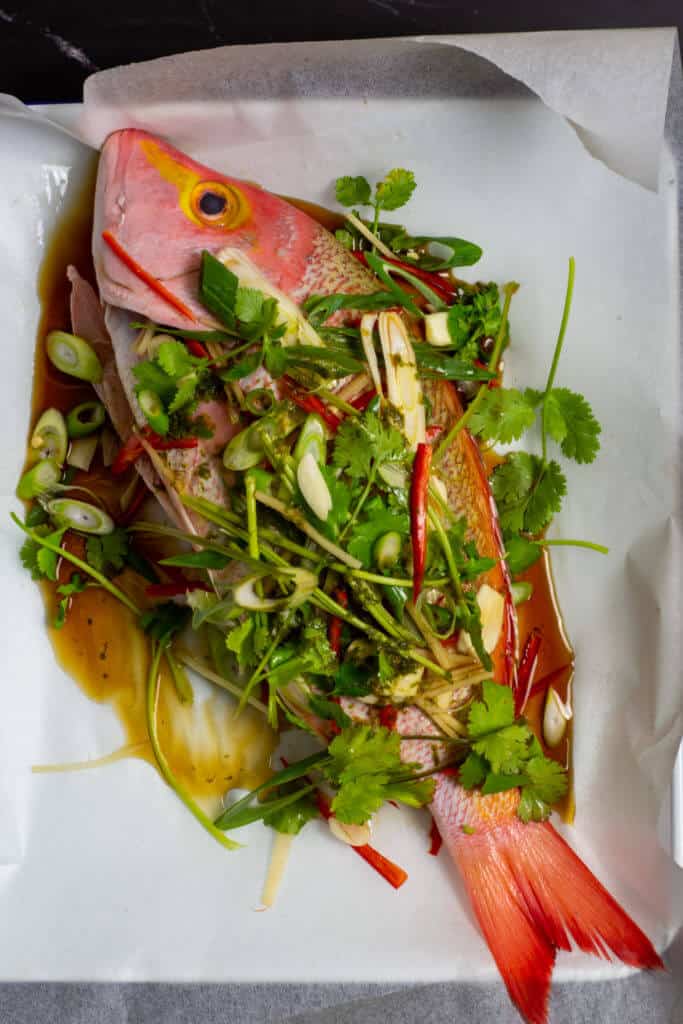 whole hussar with asian aromatics on parchment paper