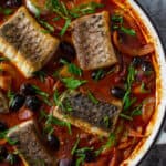 cooked spanish fish stew in casserole dish