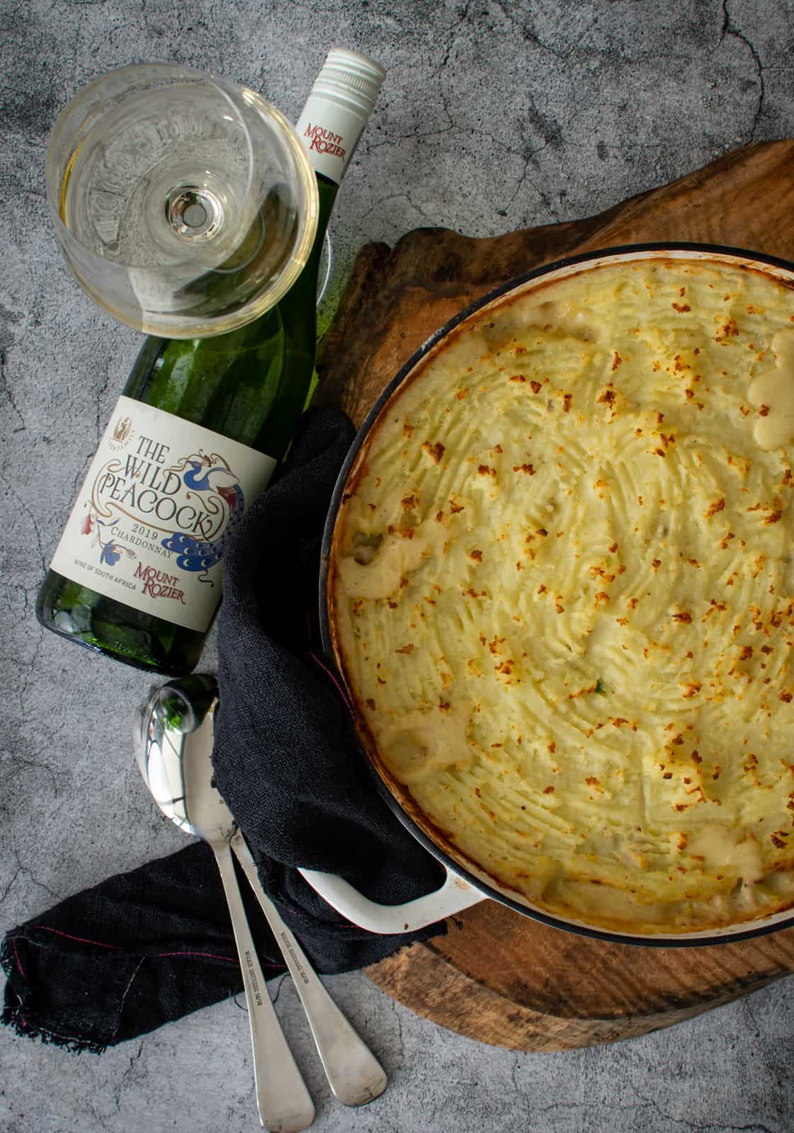 cooked chicken pie with a glass of Mount Rozier chardonnay next to it 