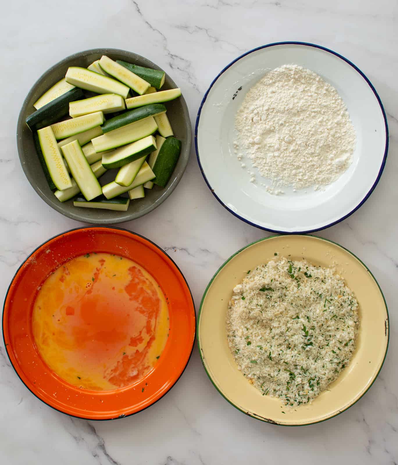 4 plates - zucchini, flour, eggs and breadcrumbs 