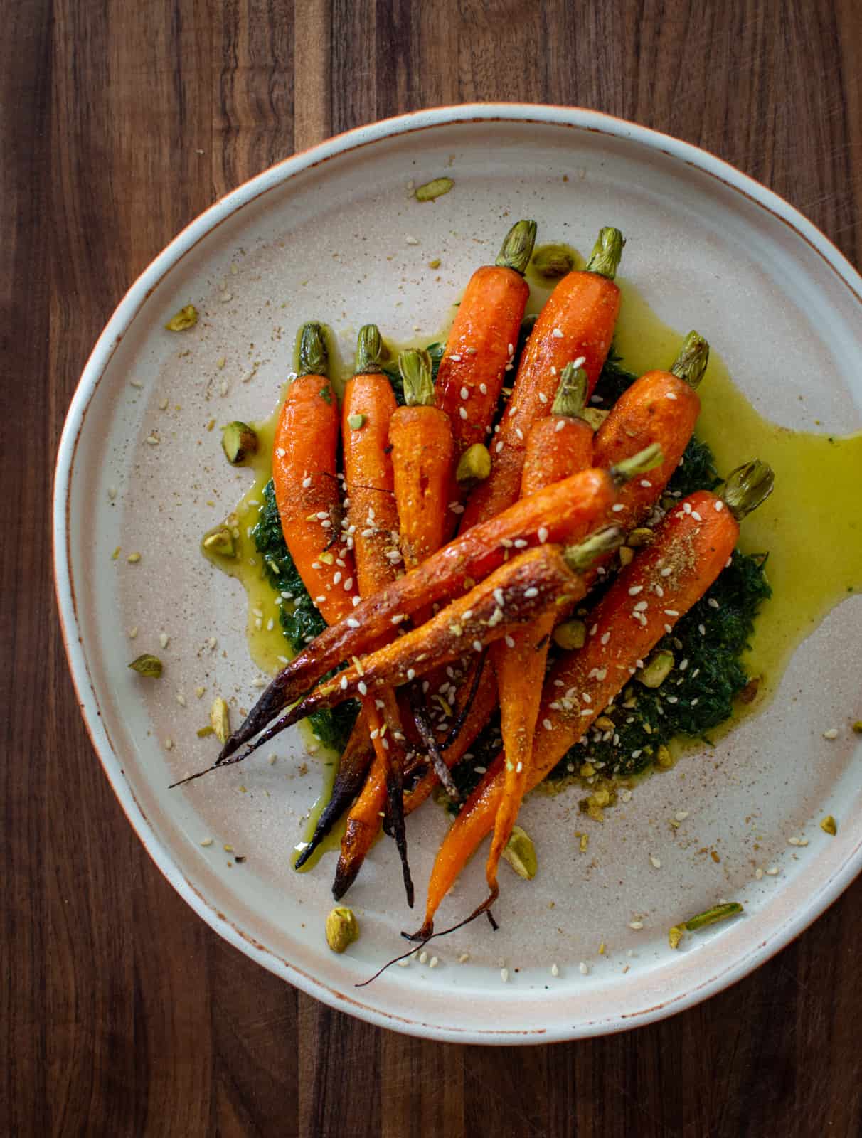 carrots, carrot top pesto and dukkah on a plate 