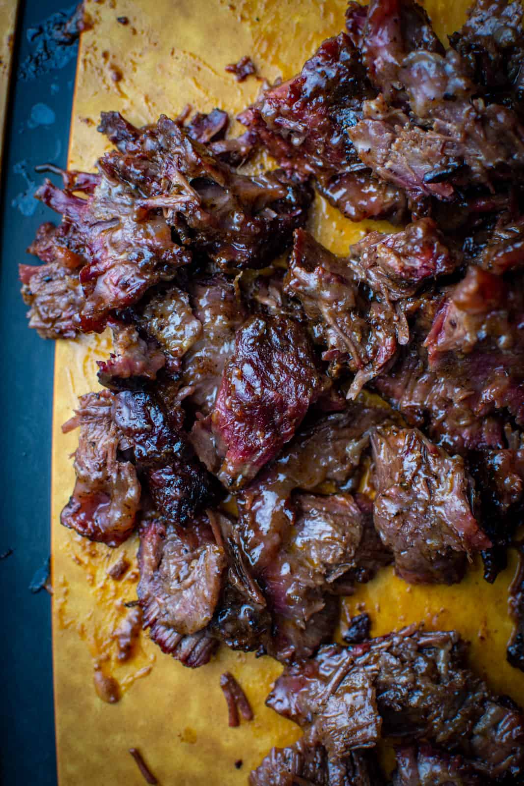 pulled smoked beef cheeks on chopping board 