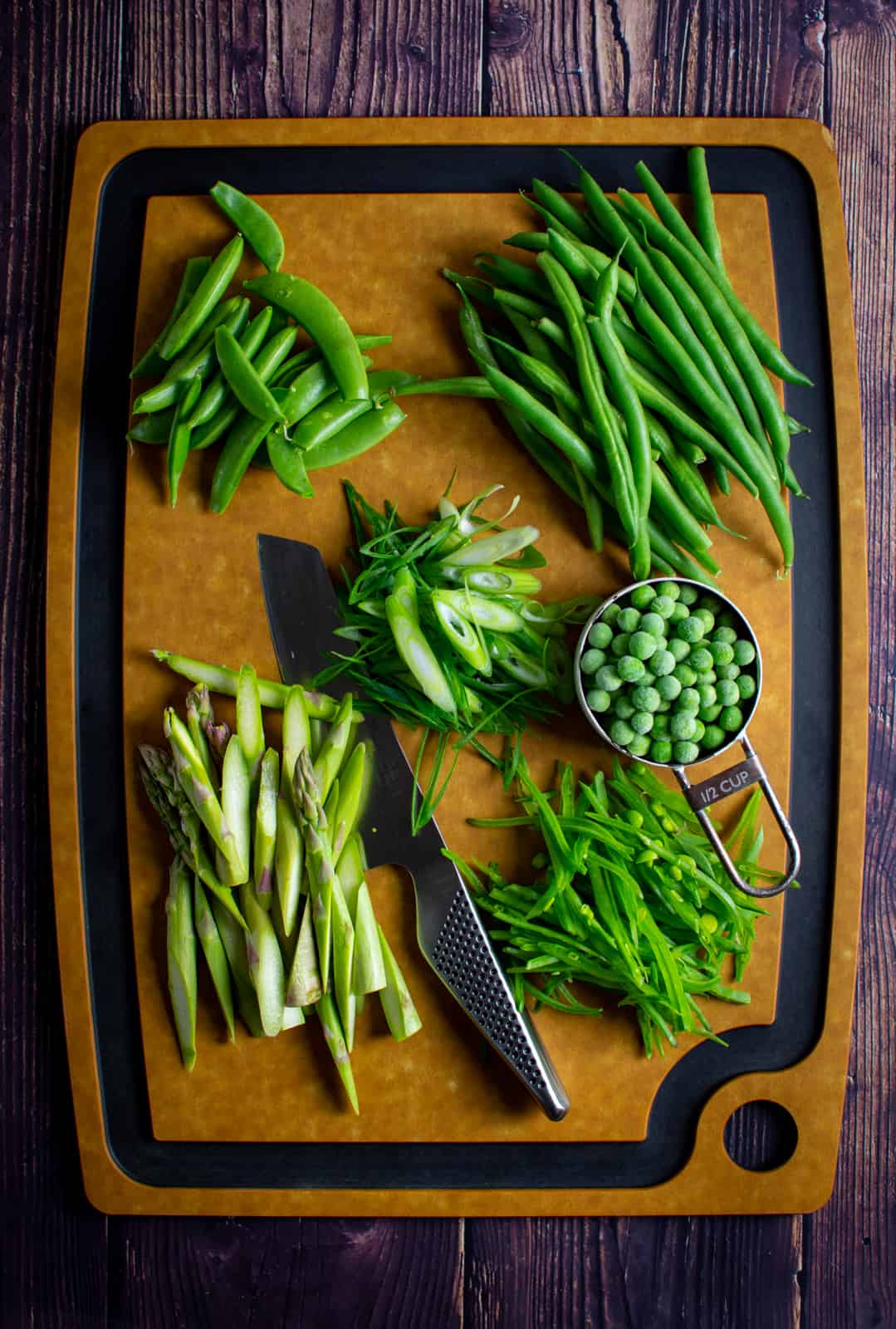 mixed green vegetables on chopping board 