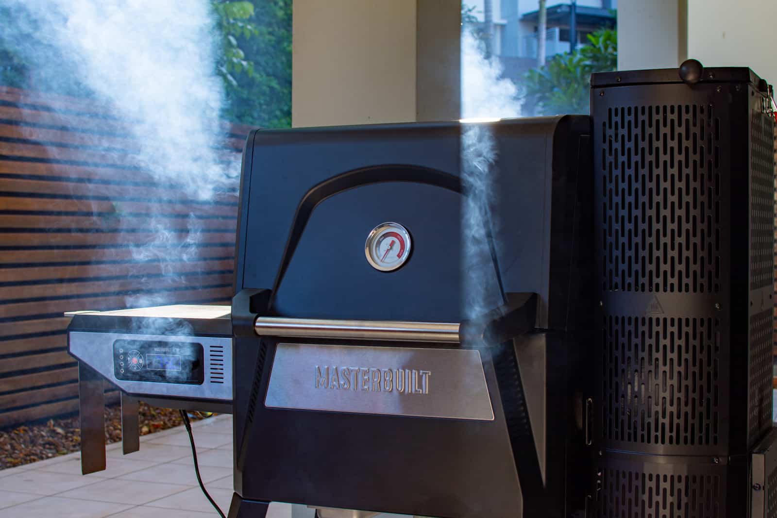 masterbuilt BBQ with smoked coming from it 
