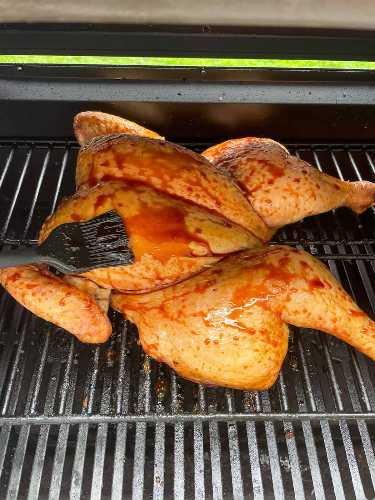 basting a smoked spatchcock chicken 