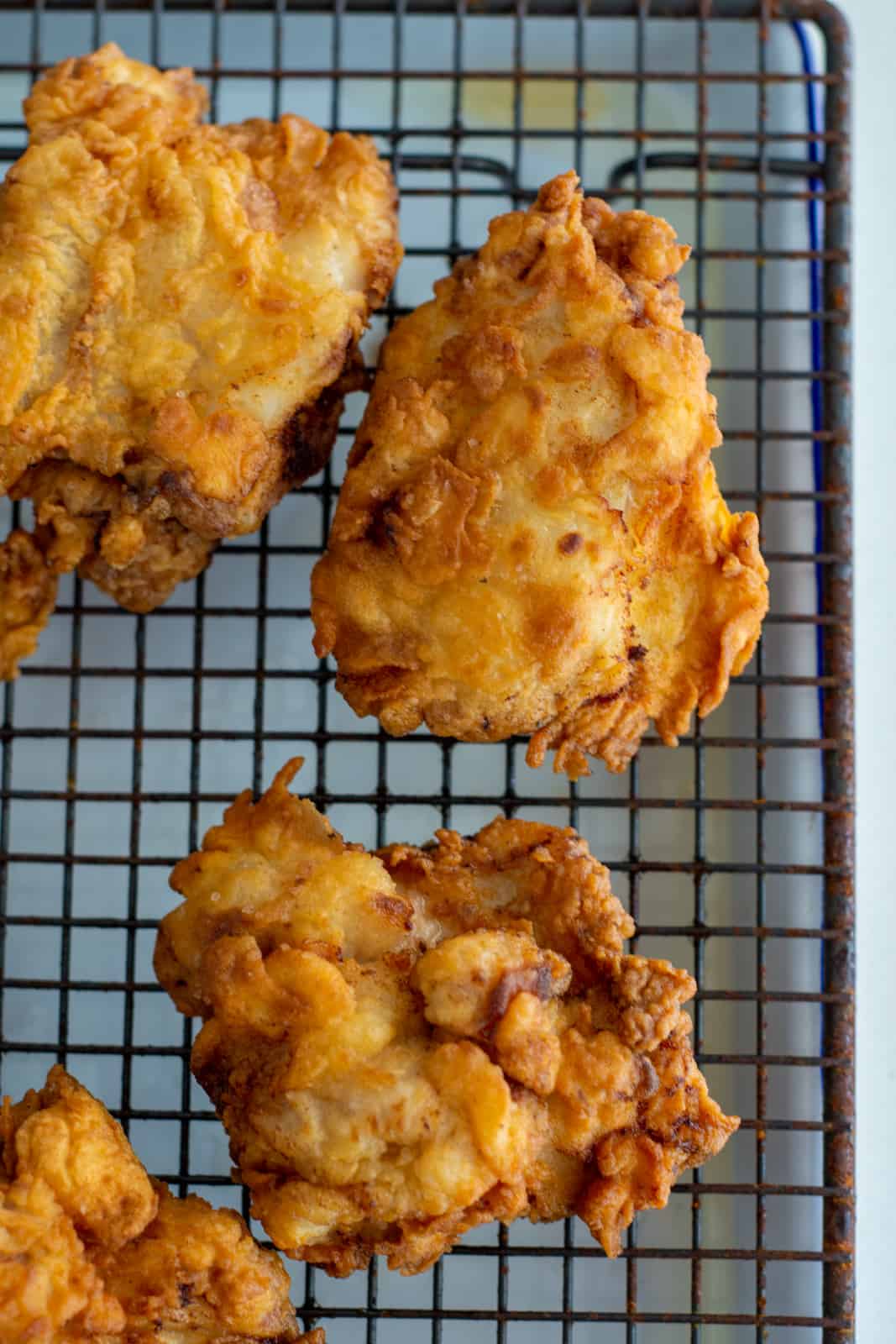 crispy fried chicken on a wire rack 